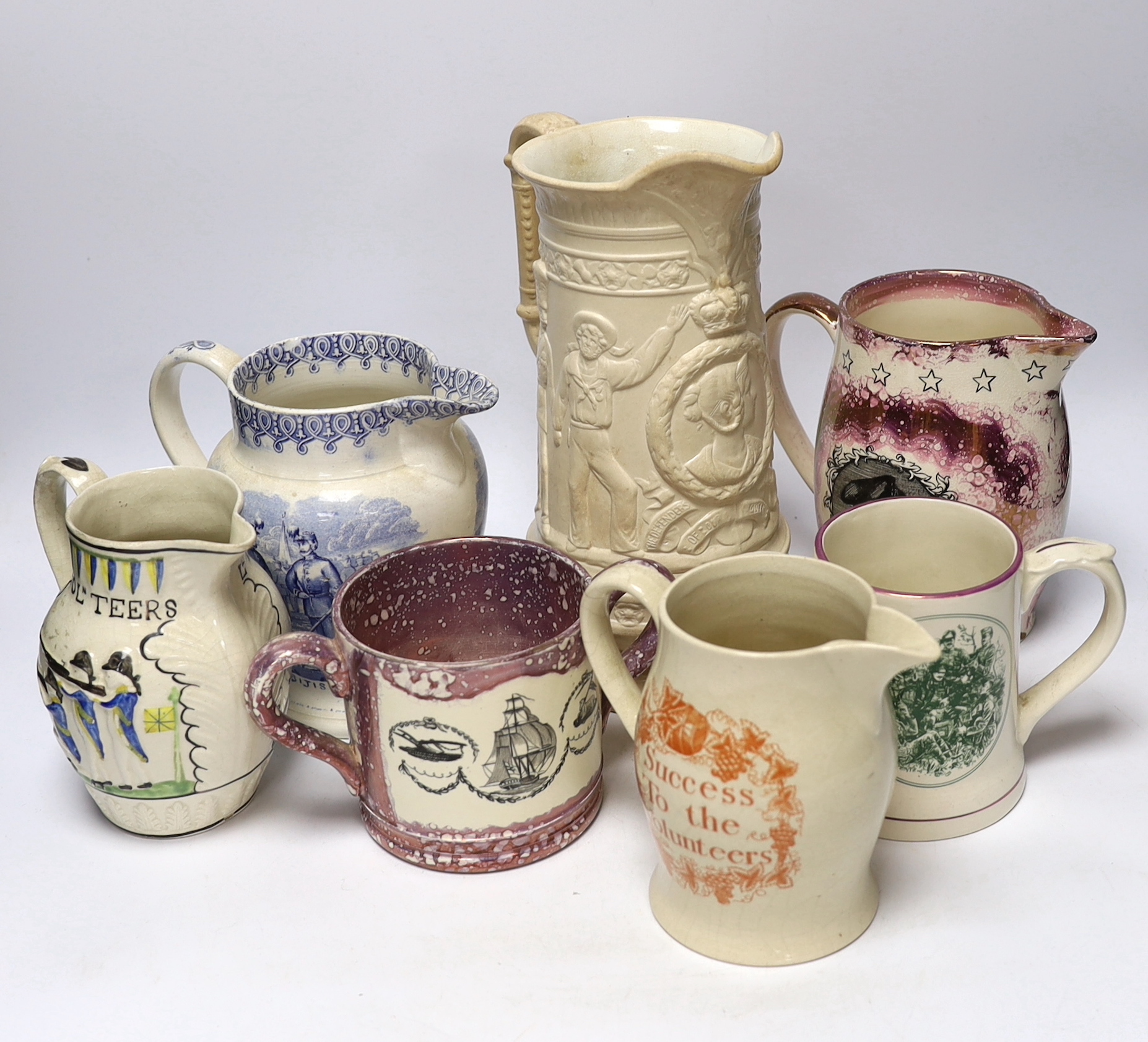 Seven military and naval themed jugs including a Leeds creamware jug 'Loyal Volunteers' inscribed 'L Volnteers' c.1803, an early 19th century success to the volunteers jug, a Sunderland pink splash lustre loving cup etc.